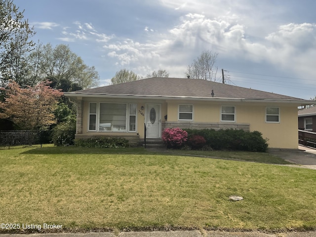 ranch-style house with stucco siding, a shingled roof, a front yard, and fence