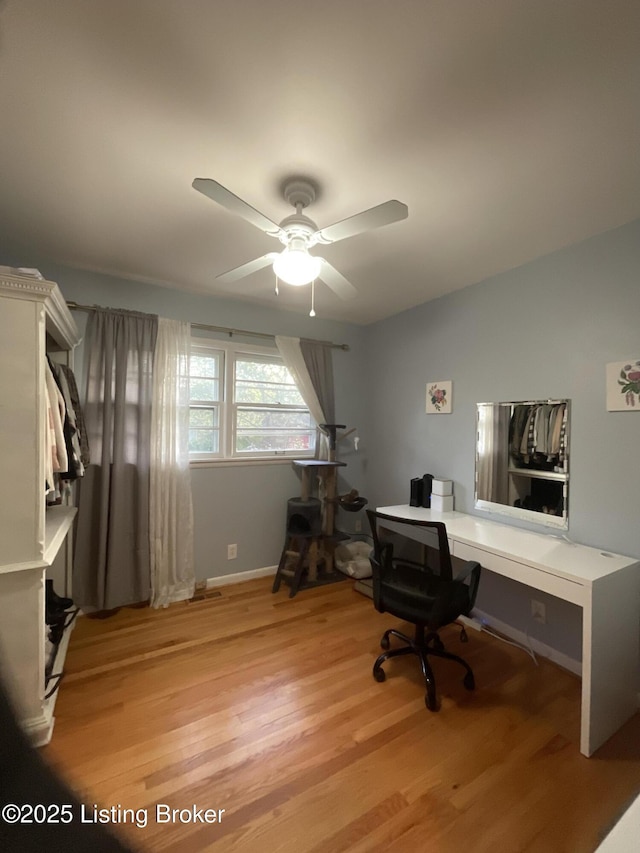 office area featuring ceiling fan, baseboards, and light wood-style floors