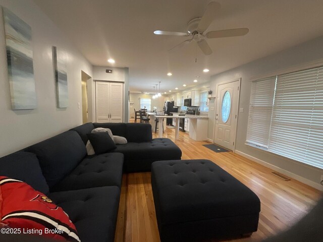 living area featuring recessed lighting, light wood-style floors, and ceiling fan