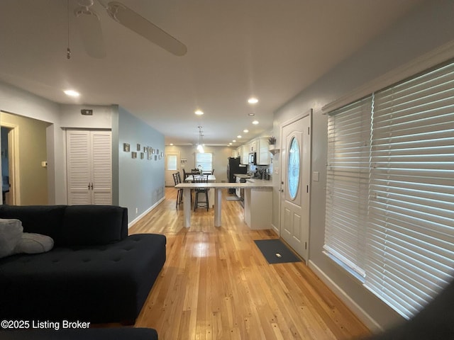 entryway featuring baseboards, recessed lighting, light wood-style floors, and ceiling fan
