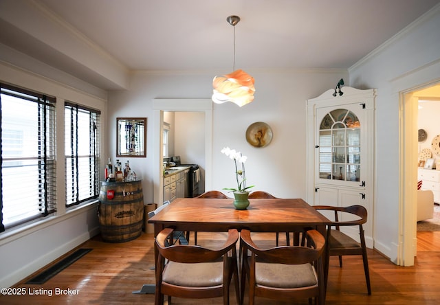 216 Cornell Pl, Louisville, KY 40207 - dining area featuring wood finished floors, crown molding, and baseboards