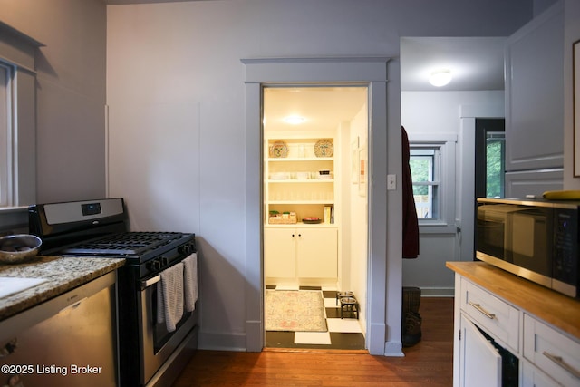216 Cornell Pl, Louisville, KY 40207 - kitchen featuring stainless steel appliances, dark wood-style floors, wood counters, white cabinets, and baseboards