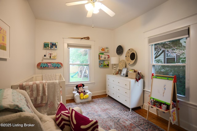 216 Cornell Pl, Louisville, KY 40207 - bedroom with wood finished floors, a nursery area, ceiling fan, and baseboards