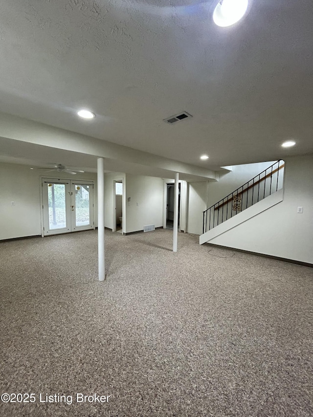 basement featuring baseboards, visible vents, recessed lighting, and stairway