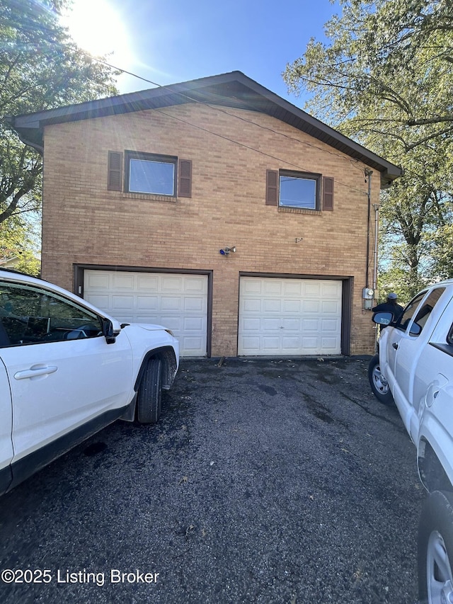 view of property exterior featuring driveway and a garage