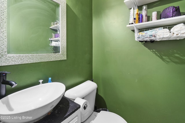 bathroom featuring toilet and vanity