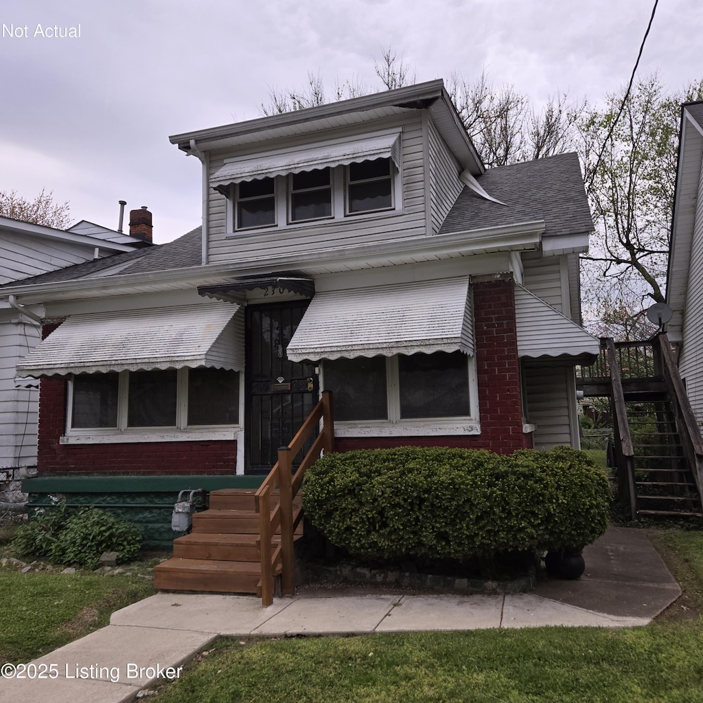 view of front of property with brick siding and stairway