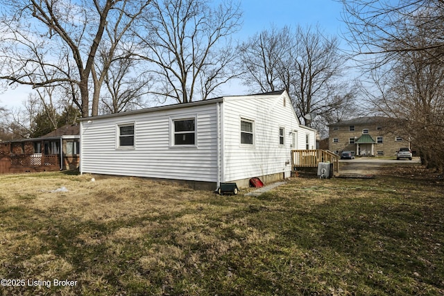 view of side of property with a lawn