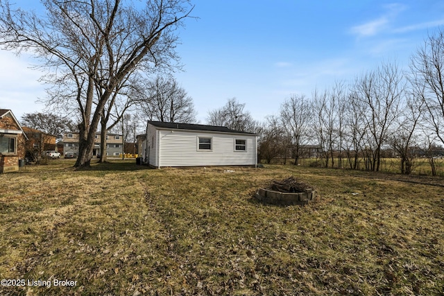 view of yard with an outbuilding and an outdoor fire pit