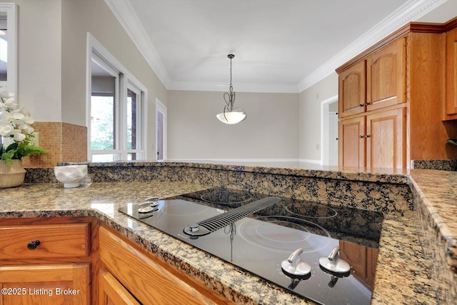 kitchen with black electric cooktop, crown molding, pendant lighting, and light stone counters