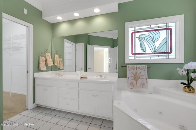 full bath featuring double vanity, tile patterned floors, a jetted tub, and a sink