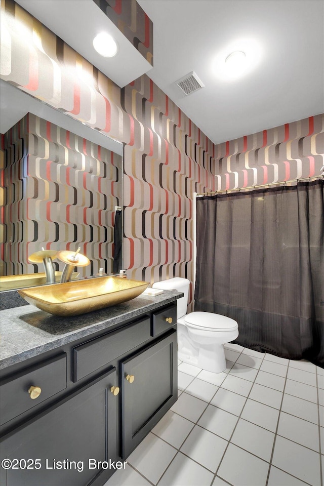 bathroom with wallpapered walls, tile patterned floors, visible vents, toilet, and vanity