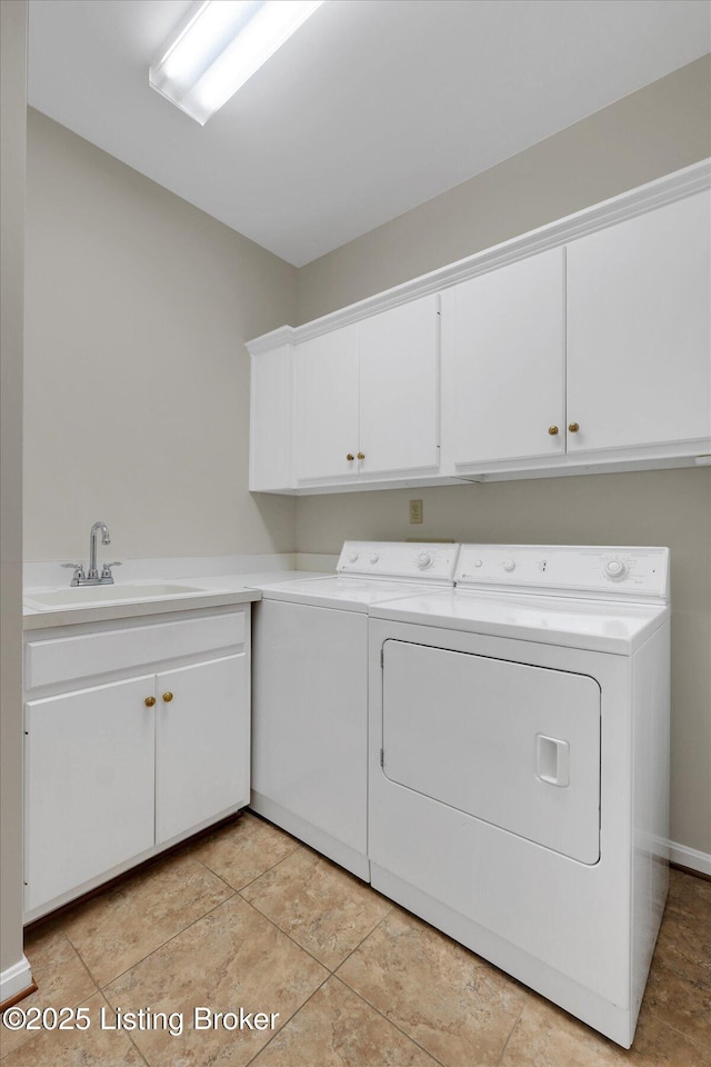 washroom featuring washing machine and clothes dryer, a sink, and cabinet space
