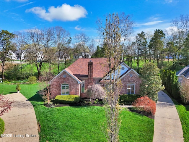 view of front of house with brick siding and a front lawn