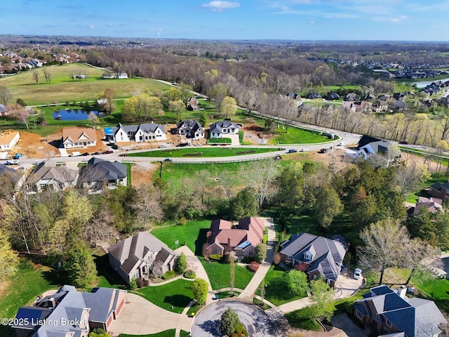 birds eye view of property with a residential view and a water view