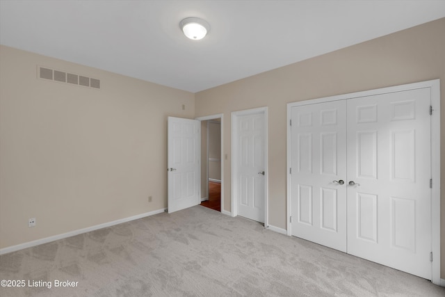 unfurnished bedroom featuring visible vents, carpet flooring, and baseboards