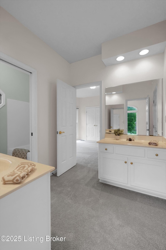 bathroom with carpet and vanity
