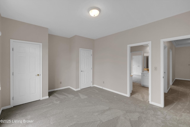 unfurnished bedroom with light carpet and baseboards