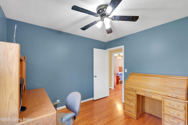 office space featuring light wood-type flooring, baseboards, and ceiling fan