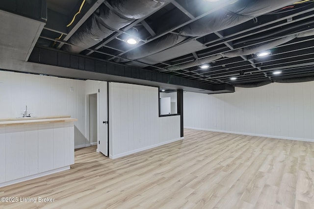 finished basement featuring light wood finished floors