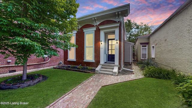 1031 S 7th St, Louisville, KY 40203 - view of exterior entry with a yard and brick siding