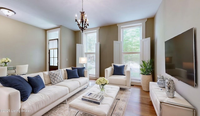 1031 S 7th St, Louisville, KY 40203 - living room with light wood-type flooring and a chandelier