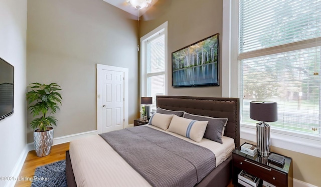 1031 S 7th St, Louisville, KY 40203 - bedroom with wood finished floors, multiple windows, and baseboards