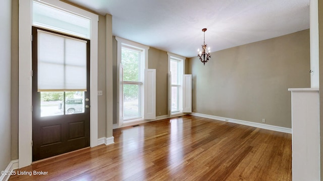 1031 S 7th St, Louisville, KY 40203 - foyer entrance featuring a chandelier, wood finished floors, and plenty of natural light