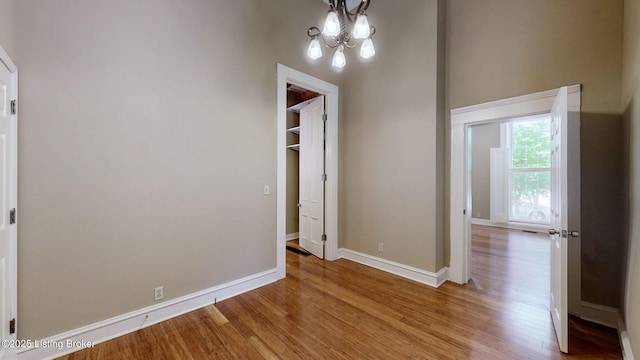 1031 S 7th St, Louisville, KY 40203 - unfurnished dining area with light wood-style flooring, baseboards, and a chandelier