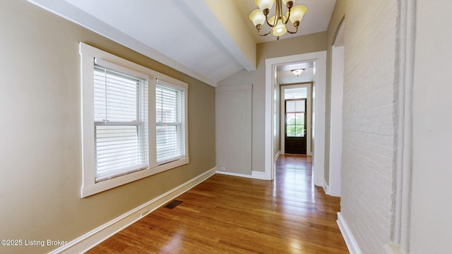 1031 S 7th St, Louisville, KY 40203 - entrance foyer with wood finished floors, a chandelier, baseboards, and lofted ceiling