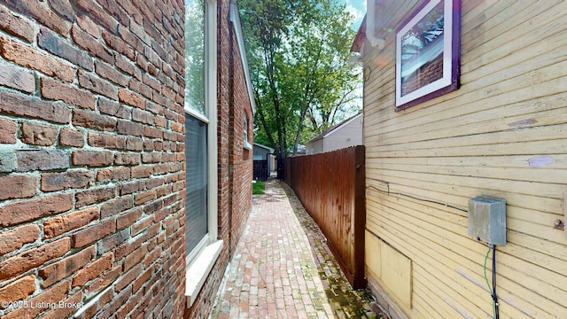 1031 S 7th St, Louisville, KY 40203 - view of side of home with fence and brick siding