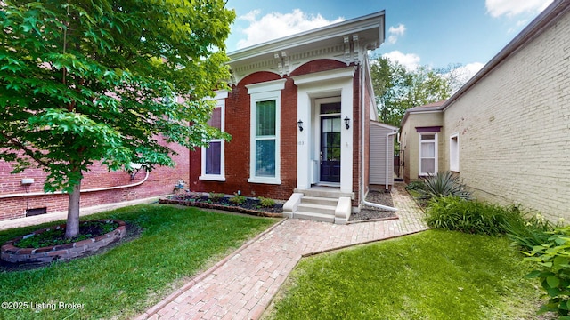 1031 S 7th St, Louisville, KY 40203 - doorway to property featuring a lawn and brick siding