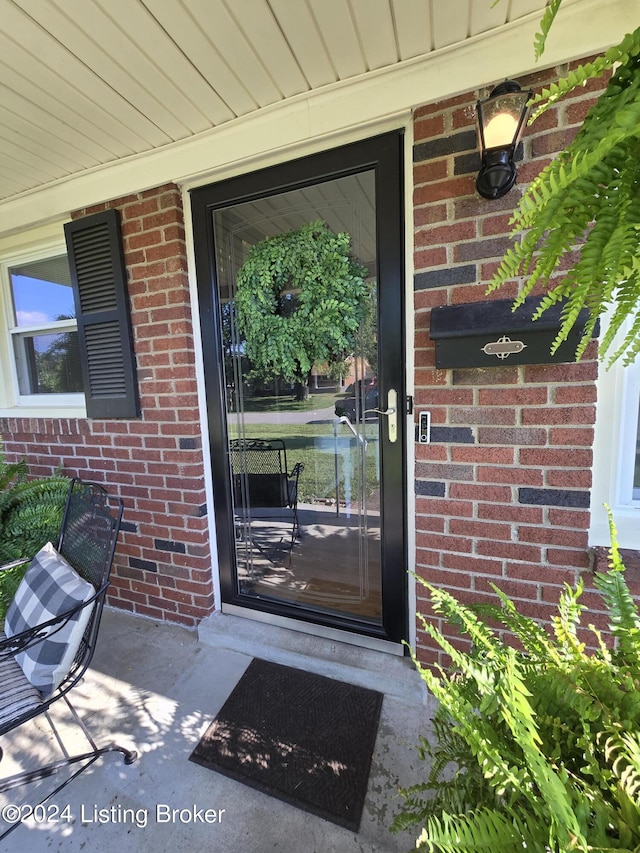 property entrance with brick siding