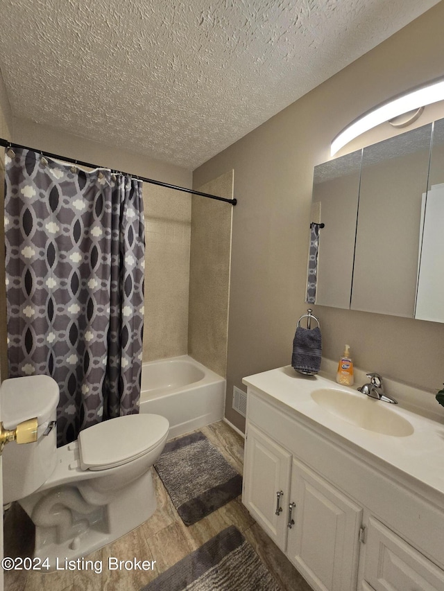 bathroom with shower / bathtub combination with curtain, visible vents, toilet, vanity, and a textured ceiling