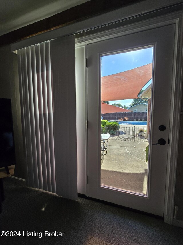 doorway with carpet flooring