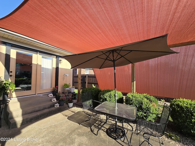 view of patio / terrace featuring fence and outdoor dining space