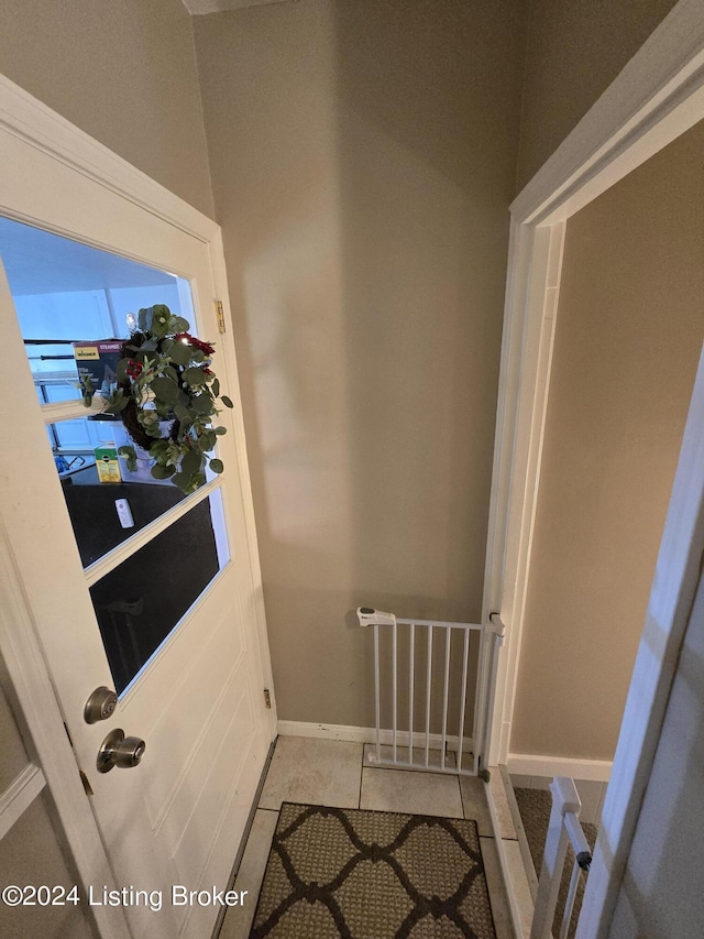 interior space with baseboards and tile patterned flooring