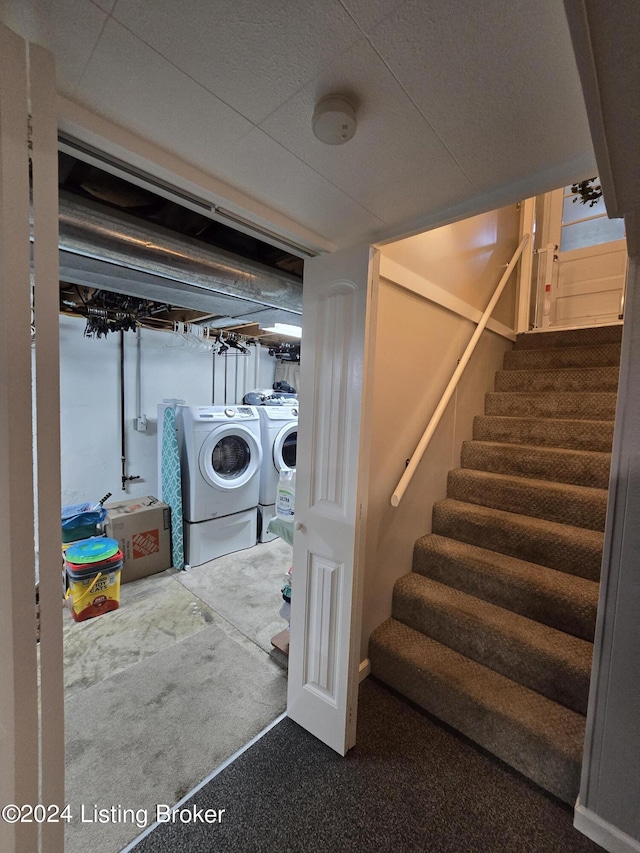 interior space featuring washing machine and dryer, laundry area, and carpet