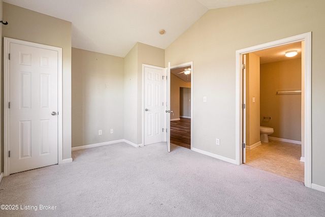 10202 Deer Vista Dr Unit 202, Louisville, KY 40291 - unfurnished bedroom with carpet floors, vaulted ceiling, ensuite bath, and baseboards