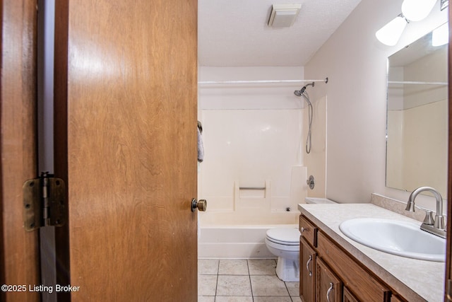 full bathroom featuring toilet, vanity, tile patterned floors, and shower / bathing tub combination