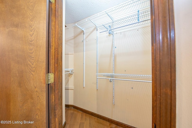 spacious closet with wood finished floors