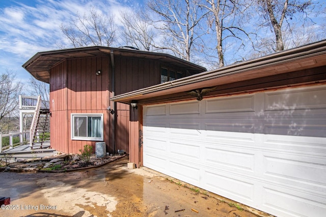 view of property exterior featuring stairway and driveway