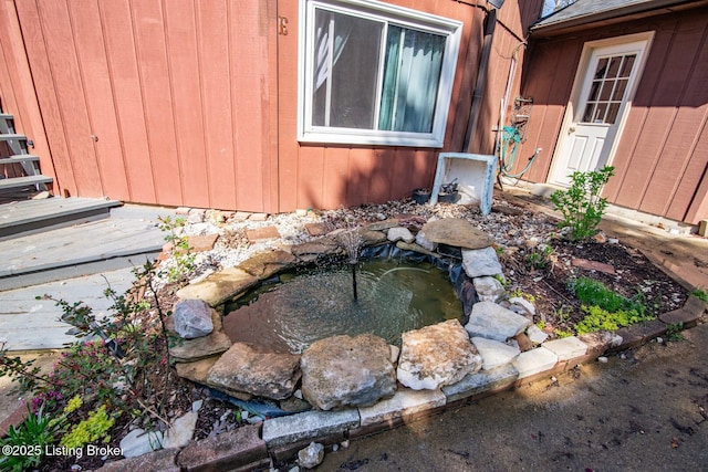 exterior details featuring a garden pond