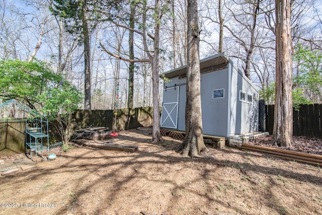 view of shed with a fenced backyard