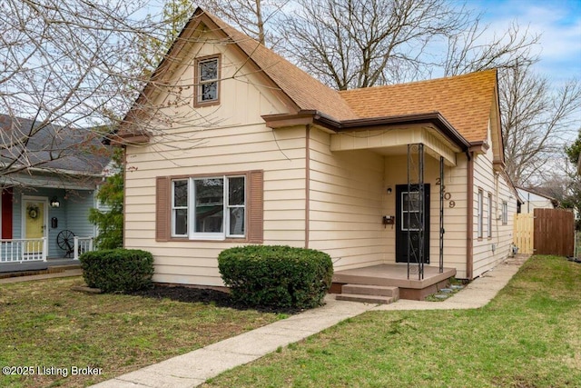2209 Shelby St, New Albany, IN 47150 - bungalow featuring a shingled roof, a front yard, and fence