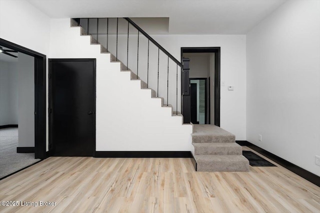 2209 Shelby St, New Albany, IN 47150 - stairway featuring baseboards and wood finished floors