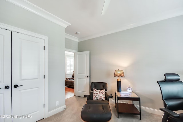 sitting room featuring crown molding and baseboards