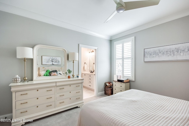 bedroom featuring light carpet, ensuite bath, crown molding, baseboards, and ceiling fan
