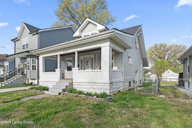 bungalow-style house with a gate, covered porch, a front lawn, and fence