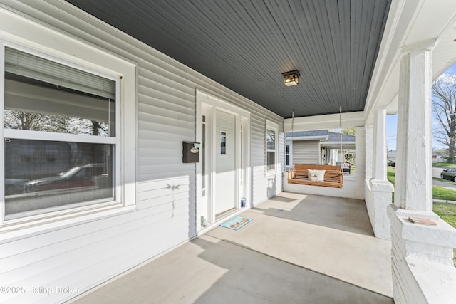 view of patio / terrace with a porch and a carport